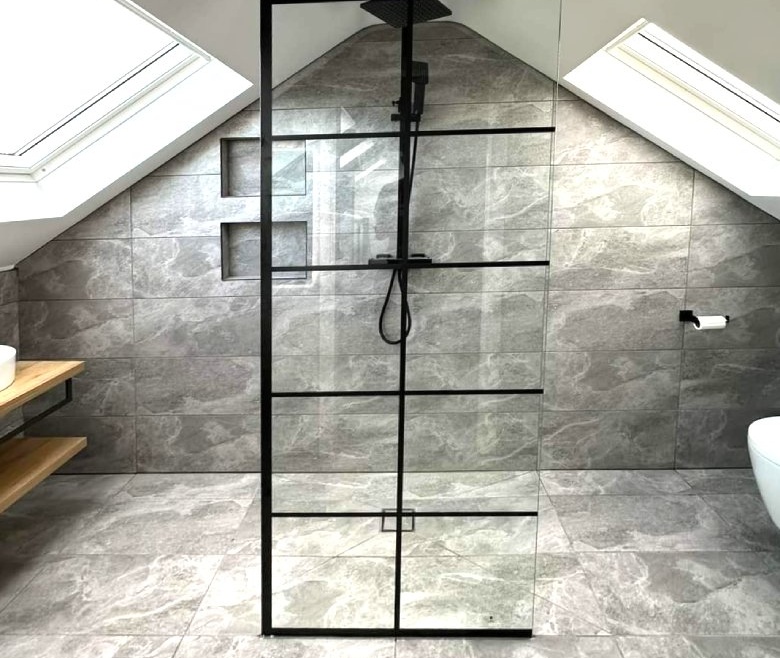 Modern ensuite bathroom in a renovated Irish attic with skylight and walk-in shower.