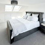 Elegant Irish attic lounge with bespoke carpentry, natural light, and warm-toned furnishings.