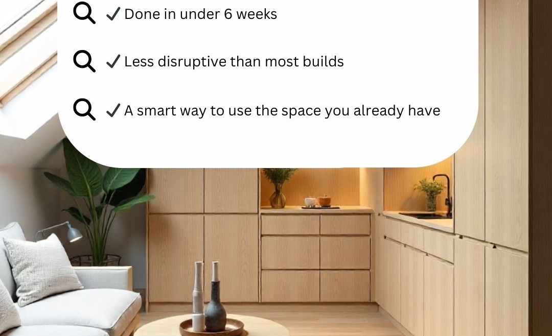 Modern attic living space with skylight, pale wood finishes, and minimalist decor